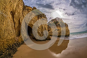 Famous rock formation with the cave on the beach of Tres Irmaos in Alvor, PortimÃ£o, Algarve, Portugal, Europe.