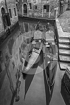 Famous romantic Venetian gondolas in a picturesque canal, Venice - Italy