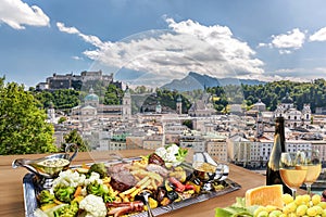 Salzburg city with gastronomic experience of typical Austrian food and wine against downtown in Austria photo