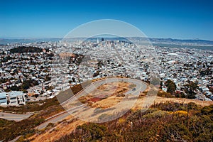 San Francisco cityscape skyline view from Twin Peaks seeing curvy road on hill.