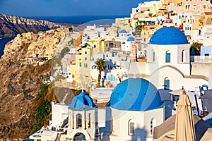 Famous Santorini view. Three blue domes and traditional white houses. Oia village, Santorini island, Greece