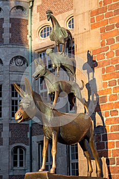 Famous sculpture of Bremen musicians on sunny day. Bronze monument of fairytale animals. Heritage of Grimm brothers.