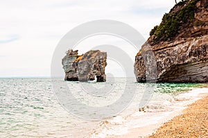 Famous sea stacks of Baia delle Zagare bay in Gargano National park. Natural rock sculptures made by Adriatic sea waves, wind and