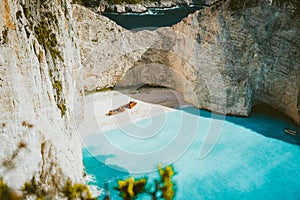 Famous shipwreck of Navagio beach with turquoise blue sea water surrounded by huge white limestone cliffs. Famous