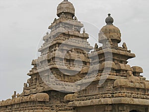 Famous Shore Temple with carvings on stone located on the sea shore at Mahabalipuram