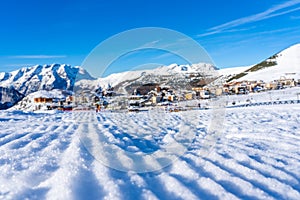 Famous ski resort in French Alps, France, Europe. Skiers skiing on the mountain, ski lift, family sports weekend