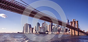 Famous Skyline of downtown New York City, Brooklin Bridge and Manhattan with skyscrapers illuminated over East River panorama. New