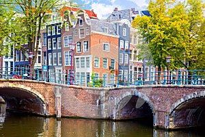 The famous sloping houses of Amsterdam. Nice view with canals and bridges. Downtown of Amsterdam. Amsterdam, Holland, Netherlands