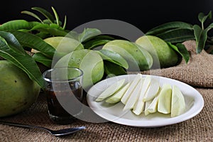 Famous snacks in Thailand, sliced tropical fresh green mango serve with sweet fish sauce