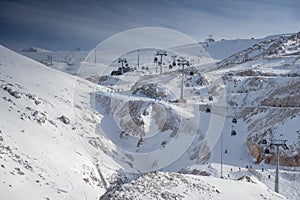 The famous snowed mountain of Parnassos with popular ski resort covered up in snow and unique nature, cable cabins, car