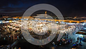 Famous square Jemaa El Fna busy with many people and lights during the night, medina of Marrakesh, Morocco