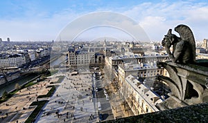 Famous Stone Gargoyle Statue In Notre Dame Cathedral With City Of Paris photo