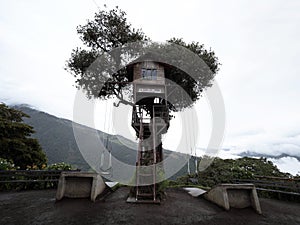 Famous swing at the end of the world at Casa del Arbol tree house near Banos Tungurahua volcano Ecuador