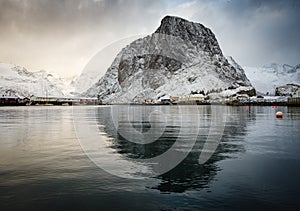 Famous tourist attraction Hamnoy fishing village on Lofoten Islands, Norway with red rorbu houses in winter.