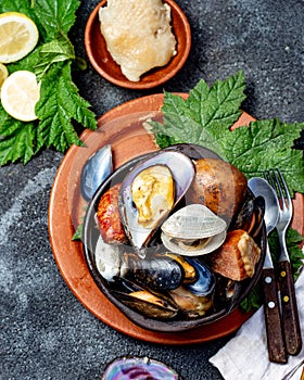 Famous traditional dish of the south of Chile and the Chiloe archipelago - Curanto al Hoyo, Kuranto. Different seafood photo