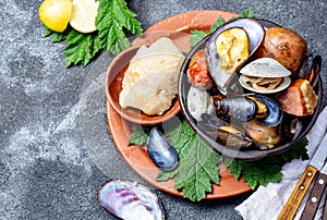 Famous traditional dish of the south of Chile and the Chiloe archipelago - Curanto al Hoyo, Kuranto. Different seafood photo