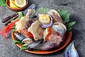 Famous traditional dish of the south of Chile and the Chiloe archipelago - Curanto al Hoyo, Kuranto. Different seafood photo