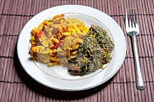 Famous traditional Jamaican ackee & saltfish breakfast, steamed callaloo seasoned with tomatoes, thyme, onions, escallion.