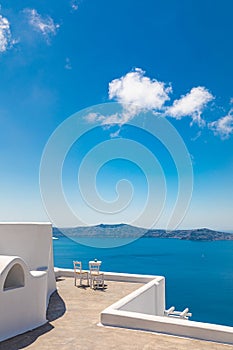 Famous travel destination, idyllic view of white architecture and blue sea under blue sky. Luxury travel and summer vacation