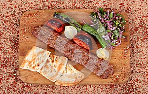 Famous Turkish Orfa Fried Kebab with Full Service with Green Pepper Tomato and Fresh Vegetables on a Table Filled with High Angle