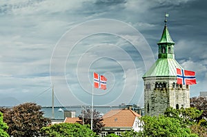 Famous ValbergtÃ¥rnet tower and its Norwegian flag in the city of Stavanger