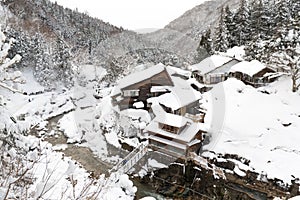 A famous valley hot spring covered in snow at Yamanouchi in Nagano.