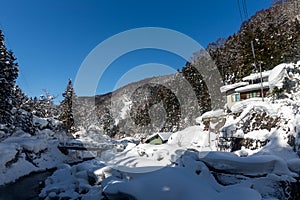 A famous valley hot spring covered in snow at Yamanouchi in Nagano.