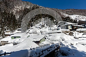 A famous valley hot spring covered in snow at Yamanouchi in Nagano.