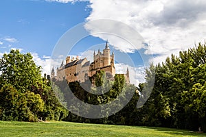 The famous view of the Alcazar of Segovia in a sunny summer day from the view point of la Pradera de San Marcos, Segovia, Spain photo