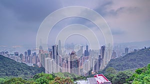 The famous view of Hong Kong from Victoria Peak night to day timelapse. Taken before sunrise with colorful clouds over