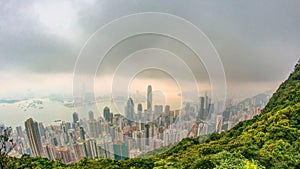 The famous view of Hong Kong from Victoria Peak timelapse. Taken at sunrise with colorful clouds over Kowloon Bay.