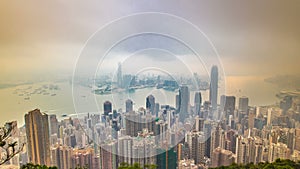 The famous view of Hong Kong from Victoria Peak timelapse. Taken at sunrise with colorful clouds over Kowloon Bay.