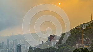 The famous view of Hong Kong from Victoria Peak timelapse. Taken at sunrise while the sun climbs over hill in Kowloon