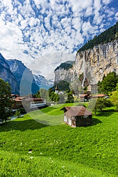 Amazing view of famous Lauterbrunnen town in Swiss Alps valley with beautiful Staubbach waterfalls in the background, Switzerland