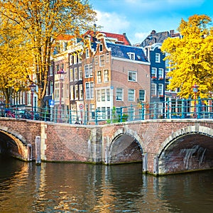 Famous view of the old heart of Amsterdam -  old sloping houses, bridges and canals. Autumn fall day in Amsterdam