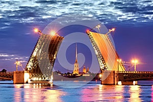 A famous view of an open drawbridge in Saint Petersburg during white nights. Palace Bridge and Peter and Paul Fortress