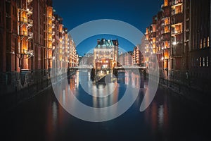 Famous view of Speicherstadt warehouse district with Wasserschloss Building at night - Hamburg, Germany