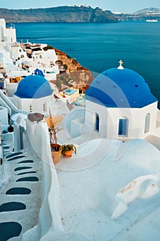 Famous view from viewpoint of Santorini Oia village with blue dome of greek orthodox Christian church