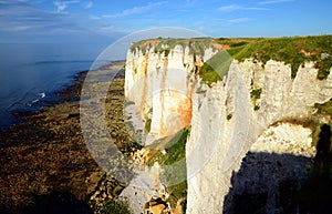 Famous white chalk cliffs of Etretat city in Normandy, France in sunset light