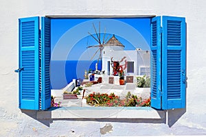 Famous windmill in Oia village, Santorini island photo