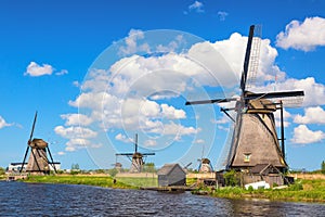 Famous windmills in Kinderdijk village in Holland. Colorful spring rural landscape in Netherlands, Europe. UNESCO World Heritage a
