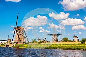 Famous windmills in Kinderdijk village in Holland. Colorful spring rural landscape in Netherlands, Europe. UNESCO World Heritage