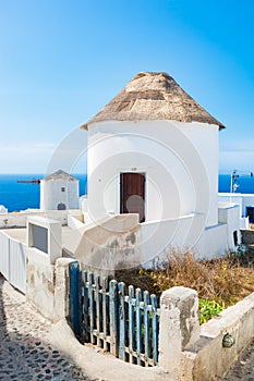 Famous windmills in Oia town on Santorini island, Greece.