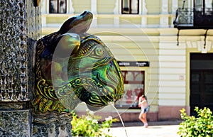 Famous Zsolnay ceramic ox head sculpture in Pecs, Hungary. fountain with blurred background.