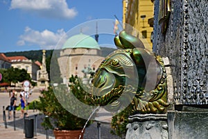 Famous Zsolnay ceramic ox head sculpture in Pecs, Hungary. fountain with blurred background.