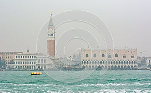 Famouse Doge palace rising above sea seen from taxi boat ride.