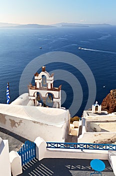 Famoust Oia town with white Cycladic houses and traditional arched bell tower on Greek Santorini island