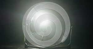 Fan blades rotate in rays of light and fog