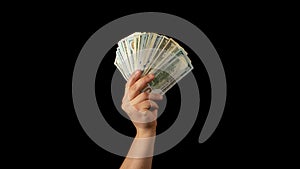 Fan of dollars in a male hand on a black background