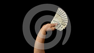 Fan of dollars in a male hand on a black background